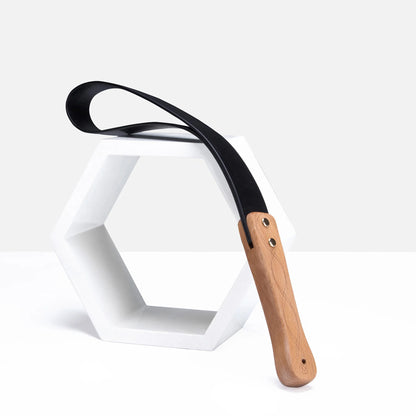 Black leather paddle with carved wood handle scene display