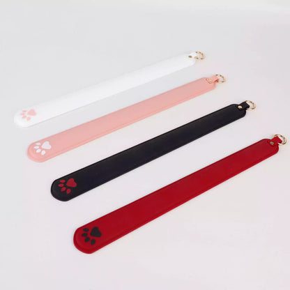 Angled perspective of four color silicone cat paw paddles