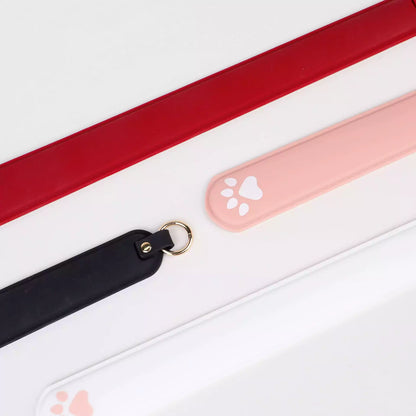 Silicone cat paw paddles displayed in themed scene