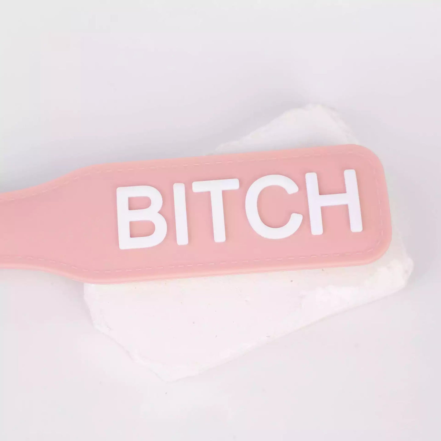 pink silicone spanking board close-up in scene