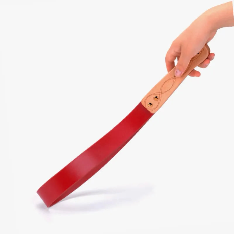 Red leather paddle with carved wood handle full view