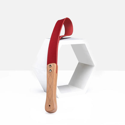 Red leather paddle with carved wood handle scene display